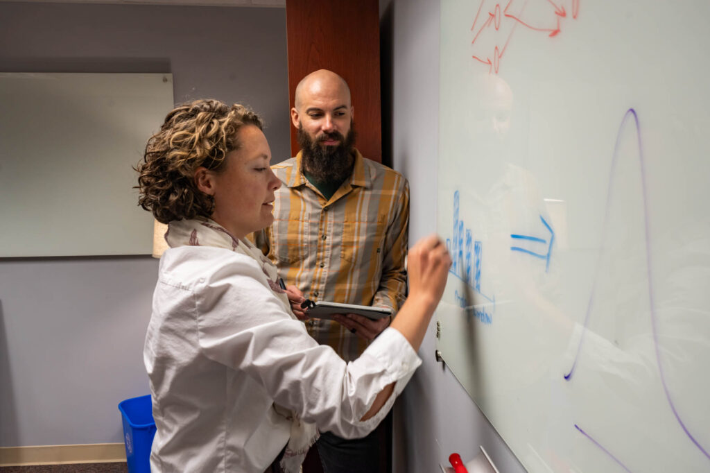 Scott Graduate Research Assistant Michael Talbot works with civil and environmental engineering Assistant Professor Frances Davenport in the CSU Engineering Building
