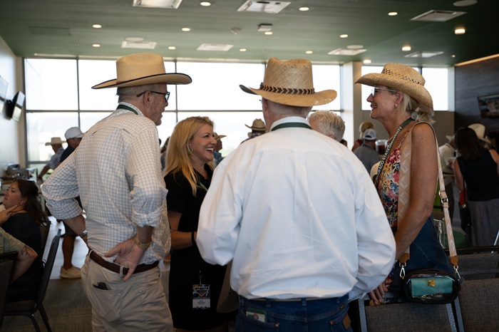 President Amy Parsons chats with cowboy hat-wearing participants at the 1870 Exclusive