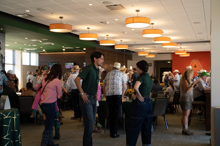 A large crowd socializes at the 1870 Exclusive