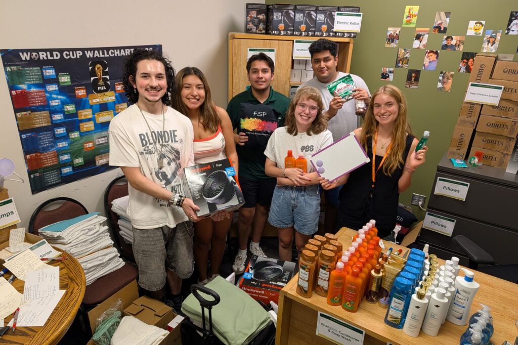Alazeah Giarrusso and other Fostering Success students prepare move-in kits for incoming students